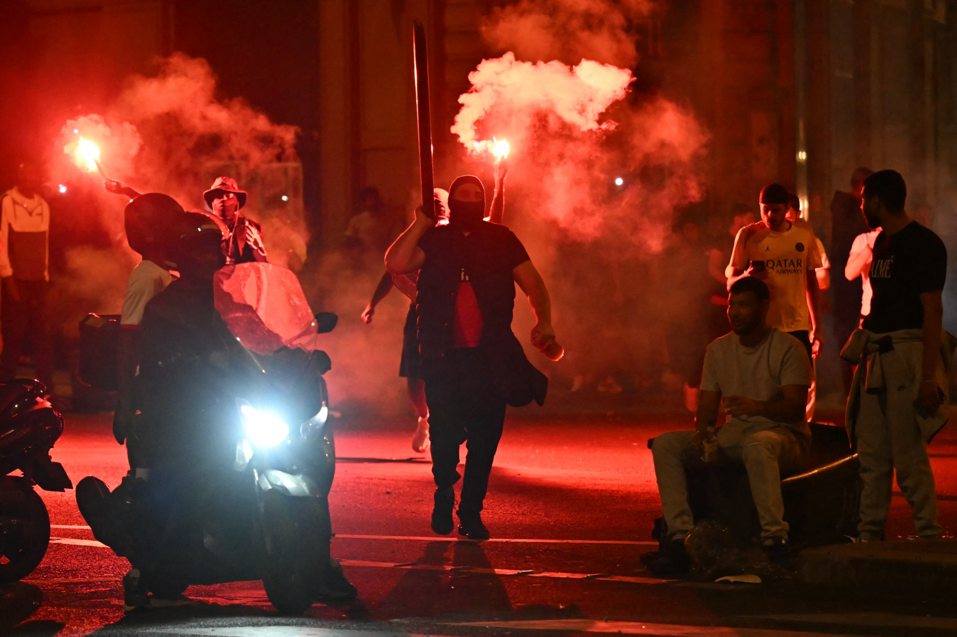 Paris Saint-Germain (PSG) supporters gather holding flares on a street in Paris early June 1, 2025, during celebrations following their 5-0 victory in the UEFA Champions League final football match between Paris Saint-Germain (PSG) and Inter Milan held in Munich. (Photo by LOU BENOIST / AFP) (Photo by LOU BENOIST/AFP via Getty Images)