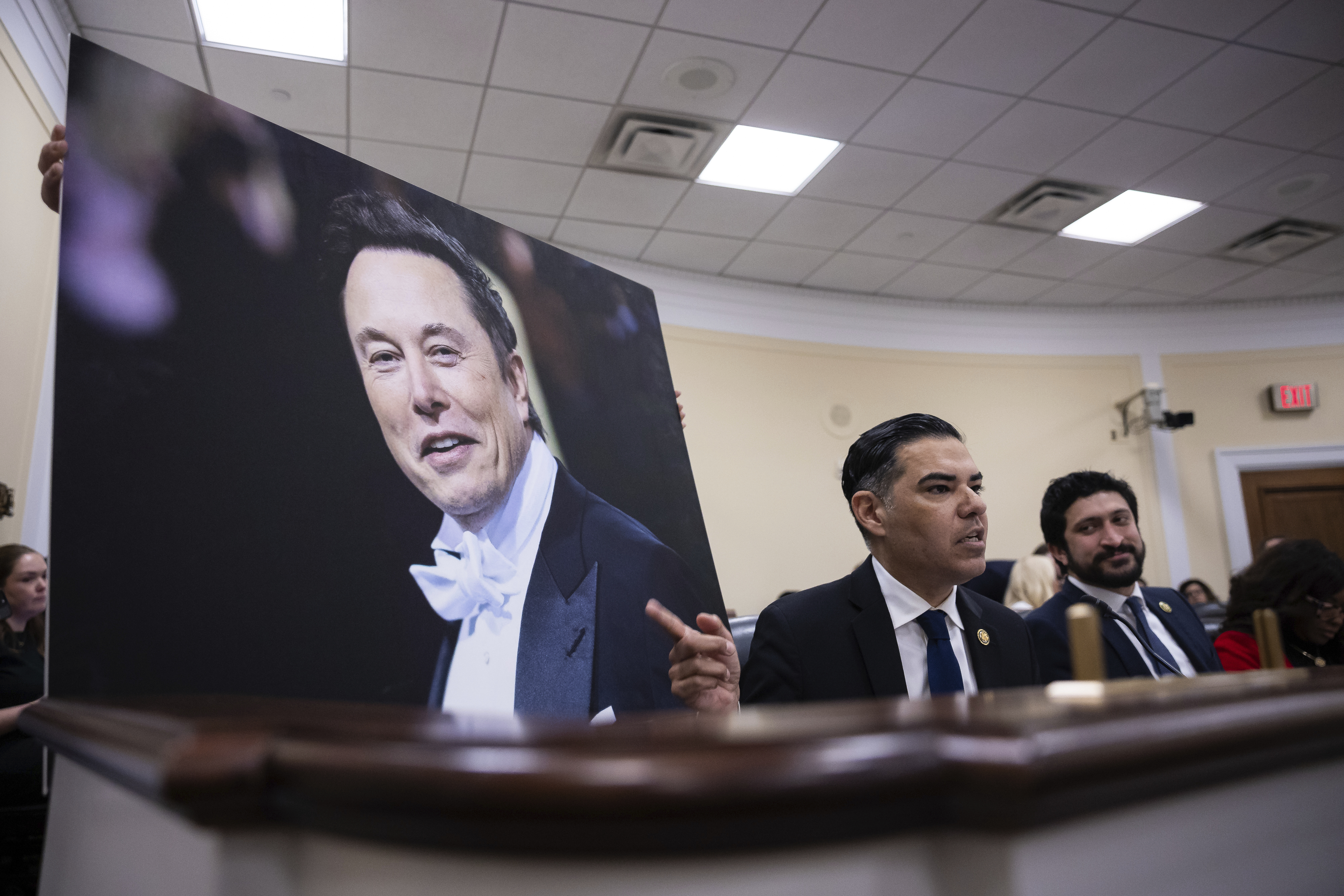 Rep. Robert Garcia (D-Calif.) displays a picture of Elon Musk while Rep. Greg Casar (D-Texas) looks on during the first hearing of the House Oversight and Accountability Subcommittee on Delivering on Government Efficiency hearing on Capitol Hill Feb. 12, 2025. (Francis Chung/POLITICO via AP Images)