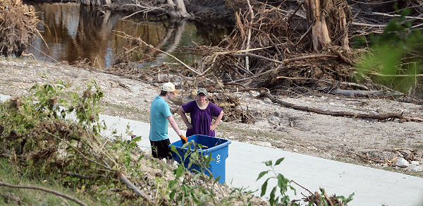 Mother and son cleanup flood debris by hand (1) (Randy Clark/Breitbart Texas)