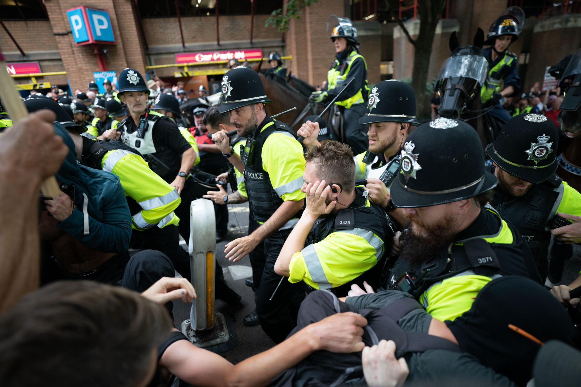 Mounted police officers scuffle with demonstrators during a protest by Abolish Asylum System and counter protesters at Castle Park in Bristol. Picture date: Saturday August 23, 2025. (Photo by Ben Birchall/PA Images via Getty Images)