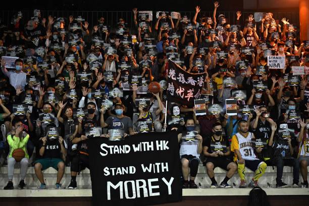 Protesters shout slogans as they hold flyers at the Southorn Playground in Hong Kong on October 15 during a rally in support of NBA basketball...