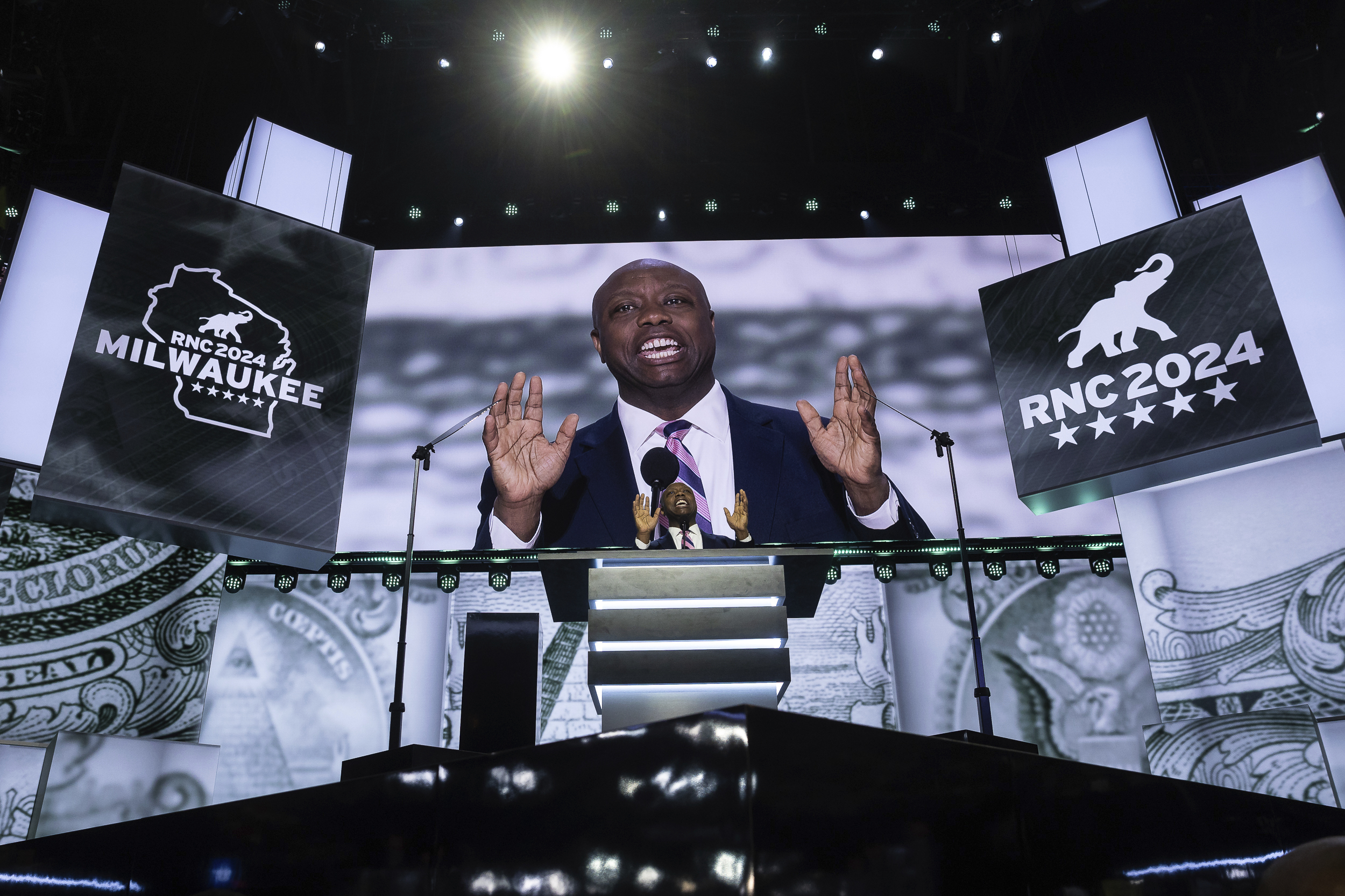 Sen. Tim Scott (R-S.C.) waves as he arrives to speak at Fiserv Forum in Milwaukee, Wis. during the first day of the Republican National Convention.