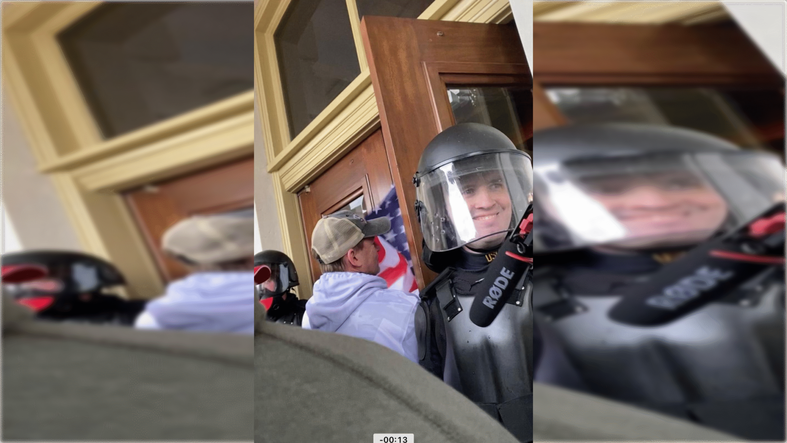 Law enforcement officers in protective gear stand near a door, with one officer smiling and an American flag visible in the background.
