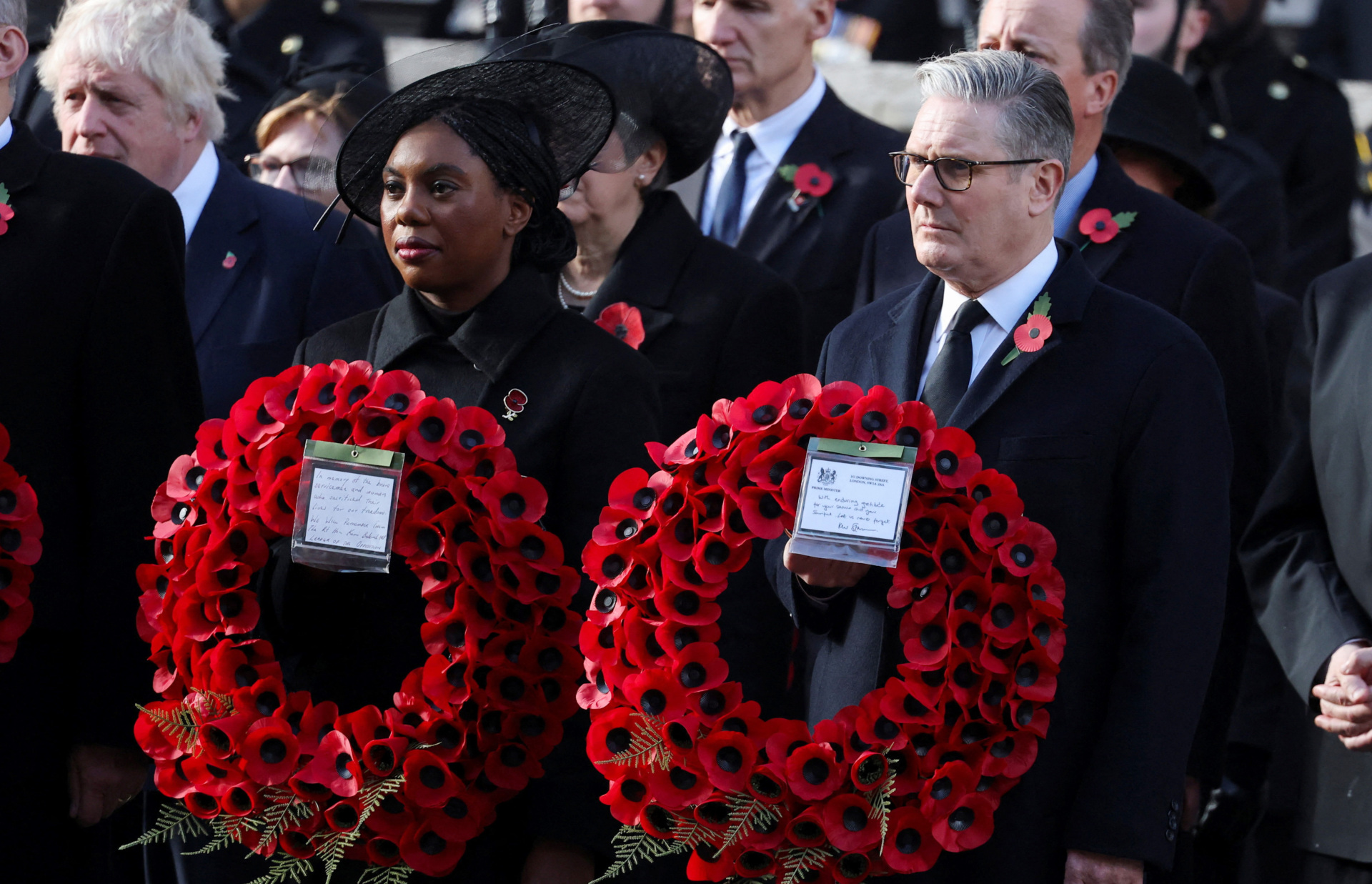 LONDON, ENGLAND - NOVEMBER 9: Prime Minister Keir Starmer and Britain's Conservative Party leader Kemi Badenoch carry wreaths during the the 2025 National Service Of Remembrance at The Cenotaph on November 9, 2025 in London, England. Every year, members of the British Royal Family join politicians, veterans and members of the public to remember those who have died in combat. (Photo by Toby Melville - WPA Pool/Getty Images)