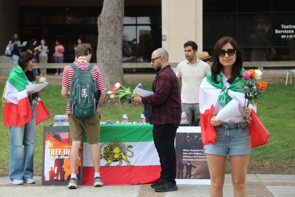 Iranian Students hand our flowers in support of Operation Epic Fury (Randy Clark/Breitbart Texas)