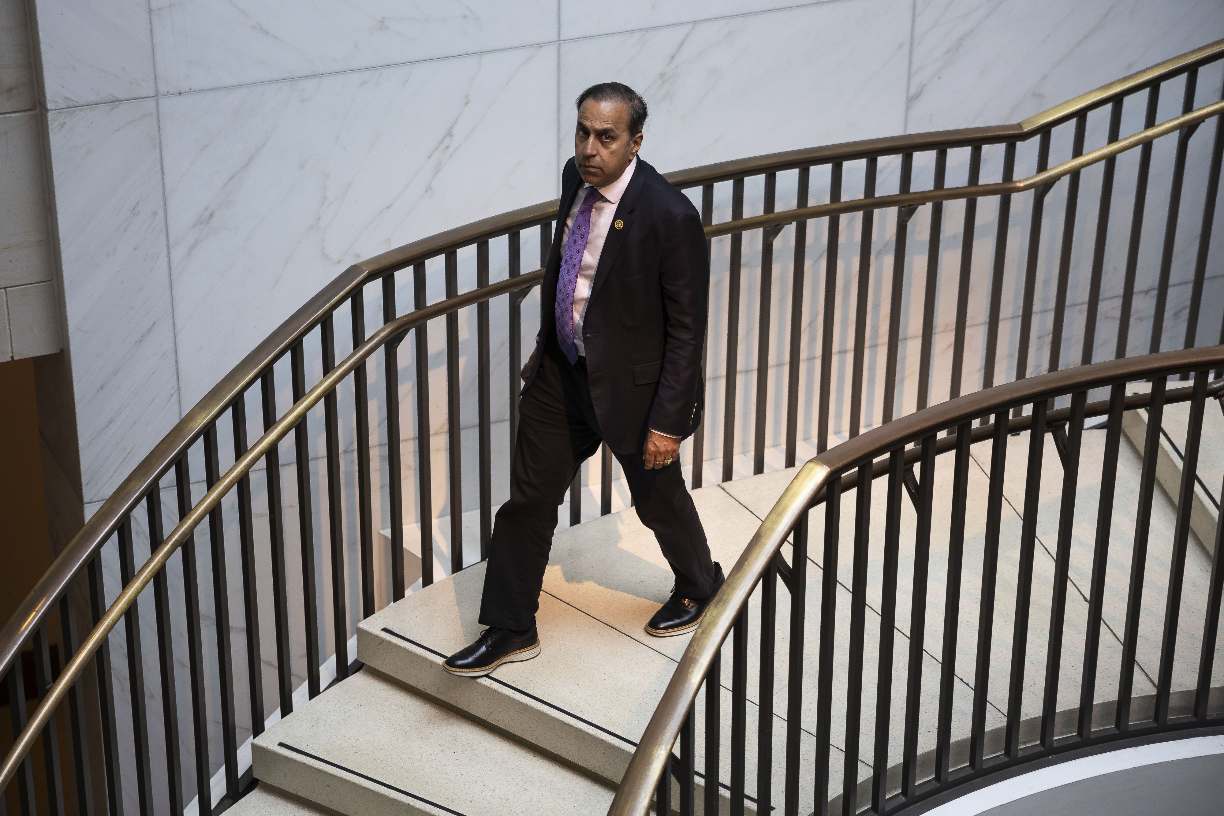 Rep. Raja Krishnamoorthi descends a staircase at the U.S. Capitol on Sept. 25, 2024. 
