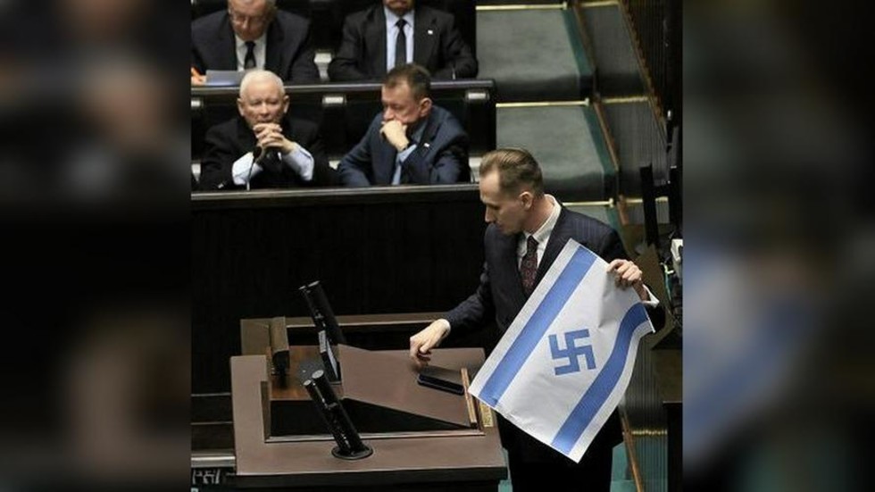 MP brandishes Israeli flag with swastika in Polish parliament (VIDEO)