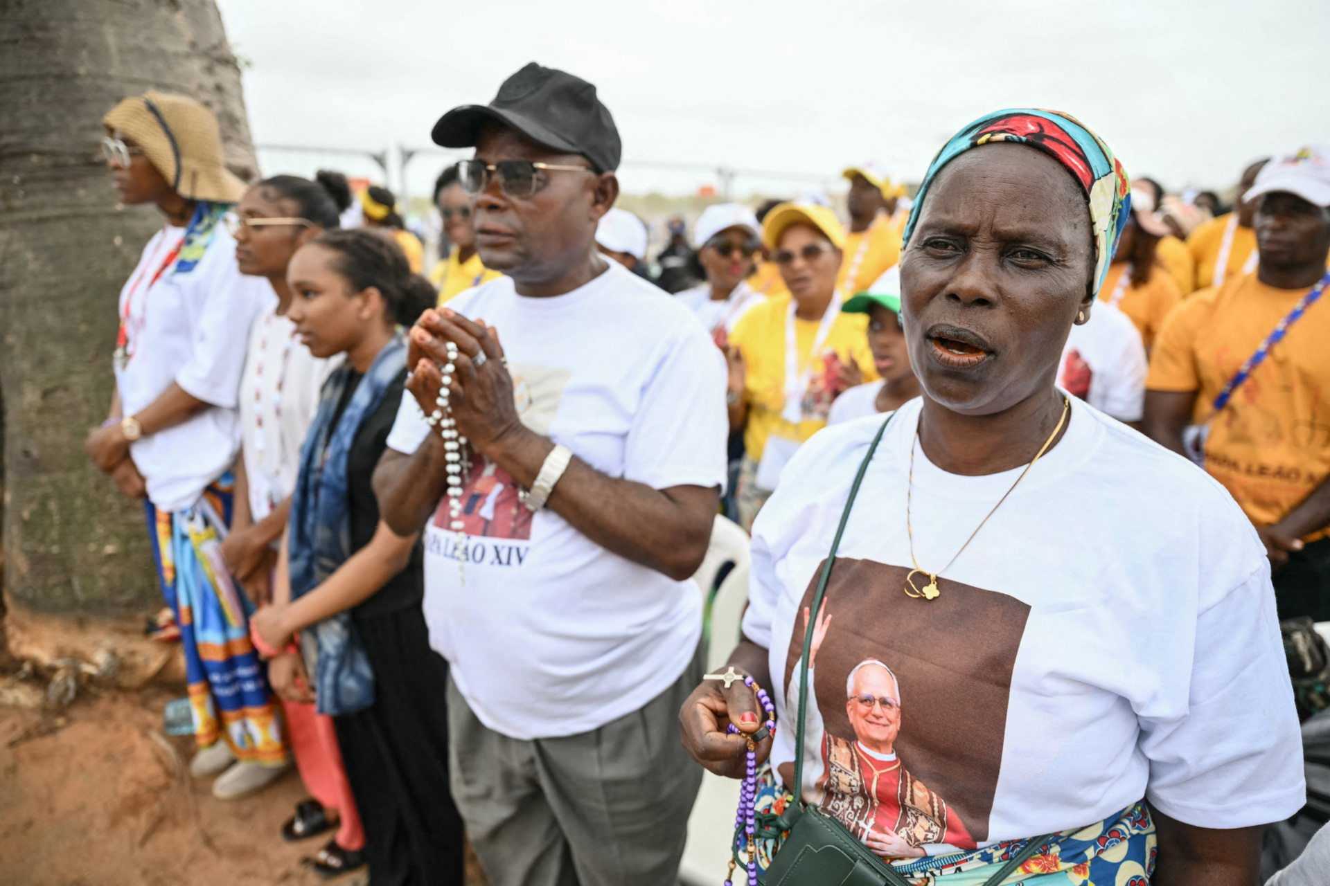 Faithfuls gather ahead of the arrival of Pope Leo XIV to lead a Holy Mass in Kalimba on the seventh day of an 11-day apostolic journey to Africa, on April 19, 2026. (Photo by Alberto PIZZOLI / AFP via Getty Images)