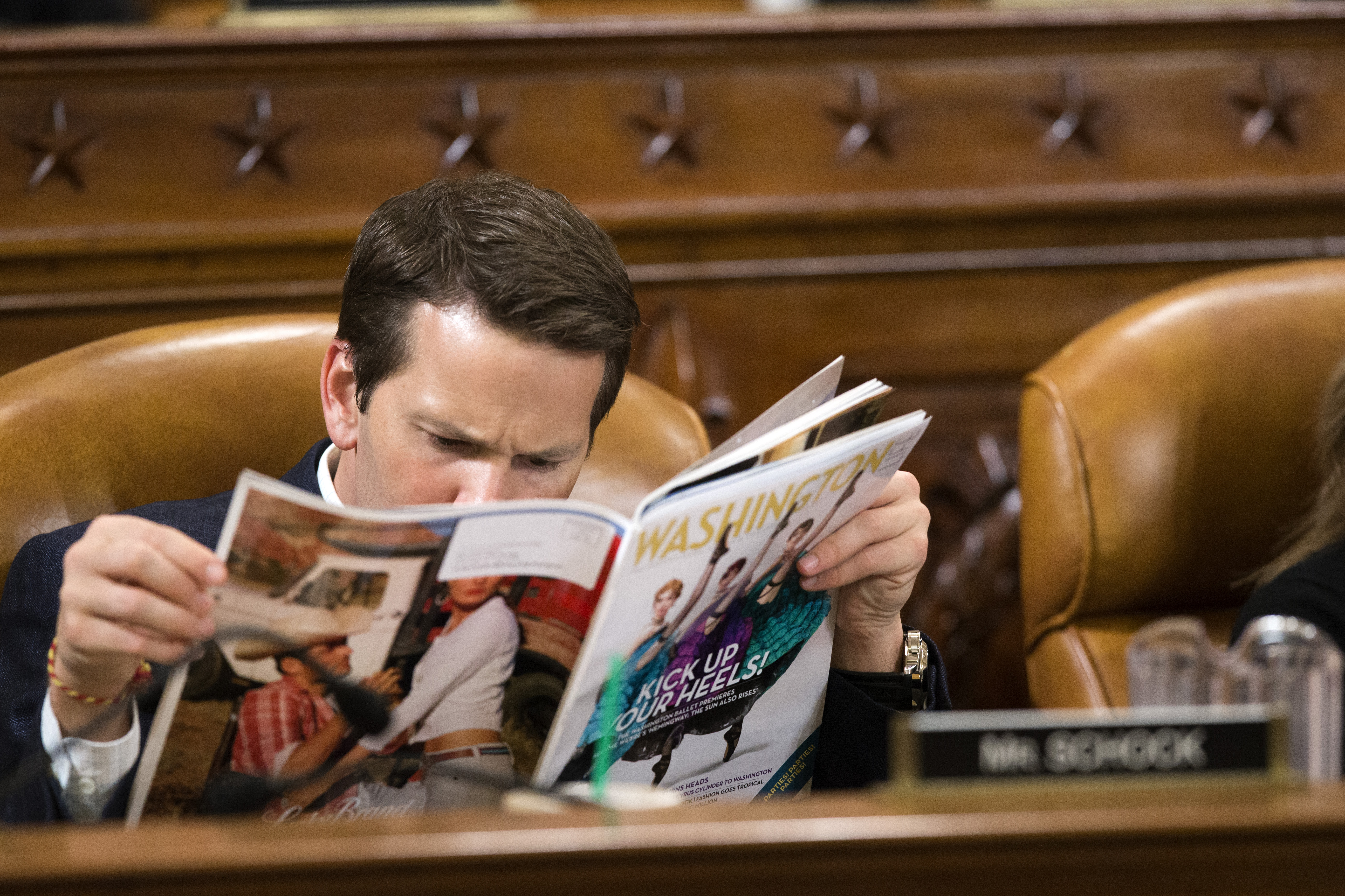 Schock peruses a copy of Washington Life magazine during a House Ways and Means Committee hearing on Capitol Hill in Washington, on April 12, 2013.