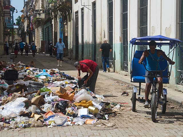 Title: Cuba Daily Life Image ID: 26152607416309 Article: A man searches through a pile of trash for items to salvage in Havana, Cuba, Monday, June 1, 2026. (AP Photo/Ramon Espinosa)