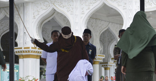 WATCH — Sharia Law: Indonesian Woman Collapses During Flogging for Kissing Partner on TikTok