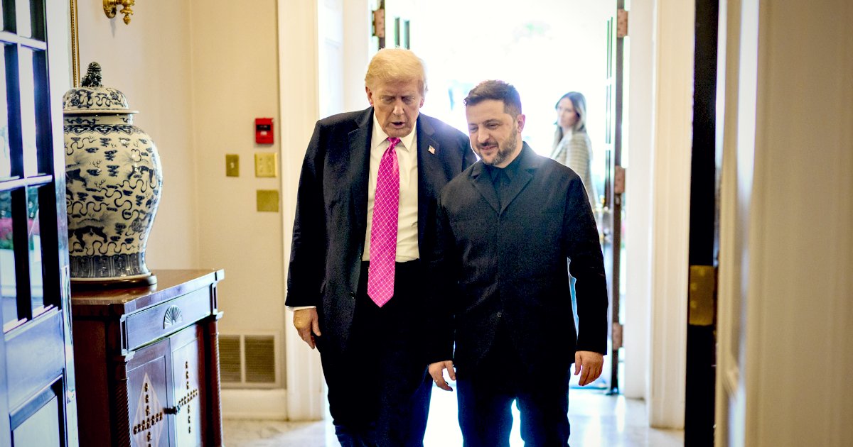 Donald Trump and Volodymyr Zelensky walk together in a formal setting, discussing matters of importance, with a decorative vase in the background.