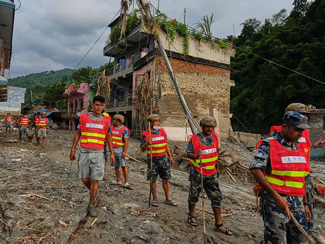 Title: Nepal Flash Floods Image ID: 26240613156437 Article: Workers clear debris in the aftermath of a flash flood in the Devighat area of Nuwakot district in Nepal, Friday, Aug. 28, 2026. (AP Photo/Rajesh Kumar Singh)