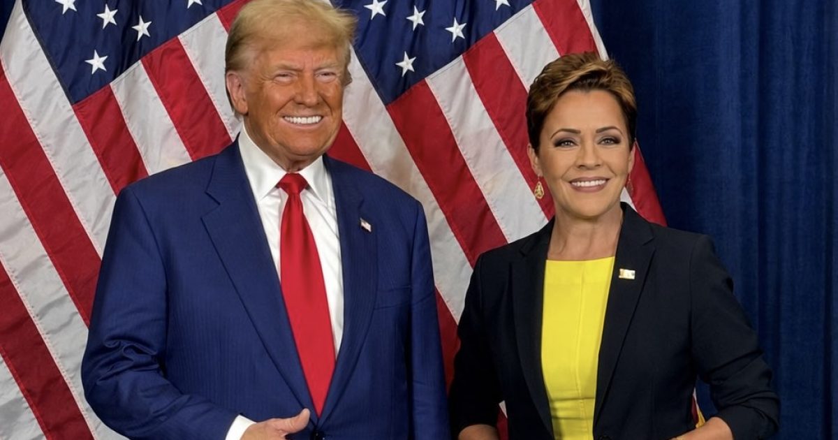 Donald Trump and Kari Lake pose together in front of American flags, showcasing their political alliance and engagement at an event.