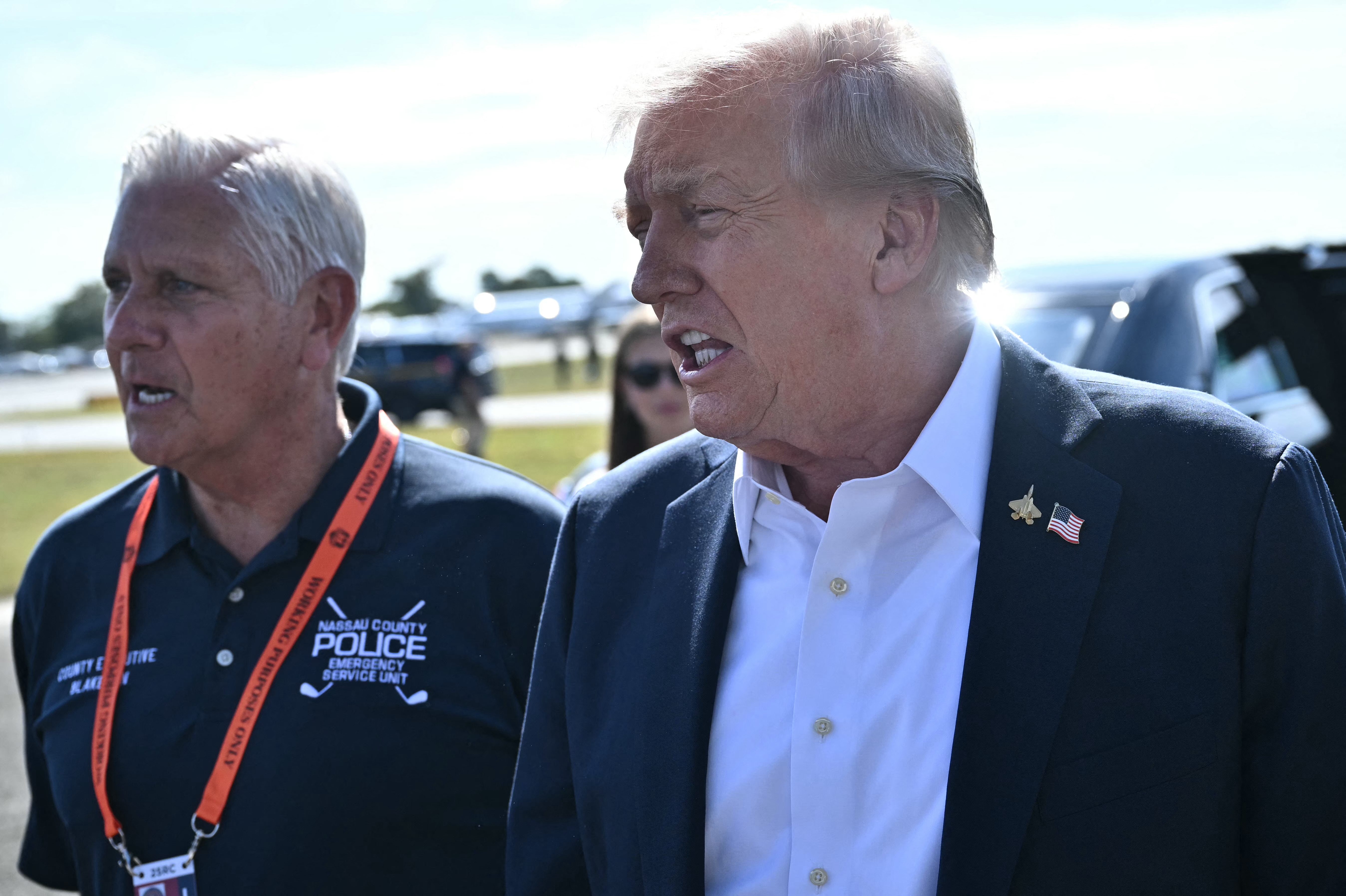 Trump speaks to the press next to Nassau County Executive Bruce Blakeman upon arrival at Republic Airport in Farmingdale, New York, on Sept. 26, 2025.