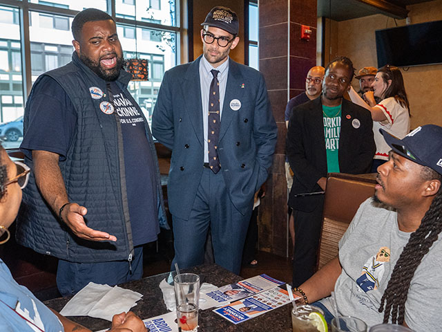 Title: Election 2026 Michigan Image ID: 26216227610310 Article: Streamer Hasan Piker, center, and Michigan state Rep. Donavan McKinney, Democratic candidate for U.S. House of Representatives in Michigan's 13th District, second from left, canvas for progressive candidates in a restaurant, ahead of the Michigan Democratic primary, Monday, Aug. 3, 2026, in Detroit. (AP Photo/Julia Demaree Nikhinson)