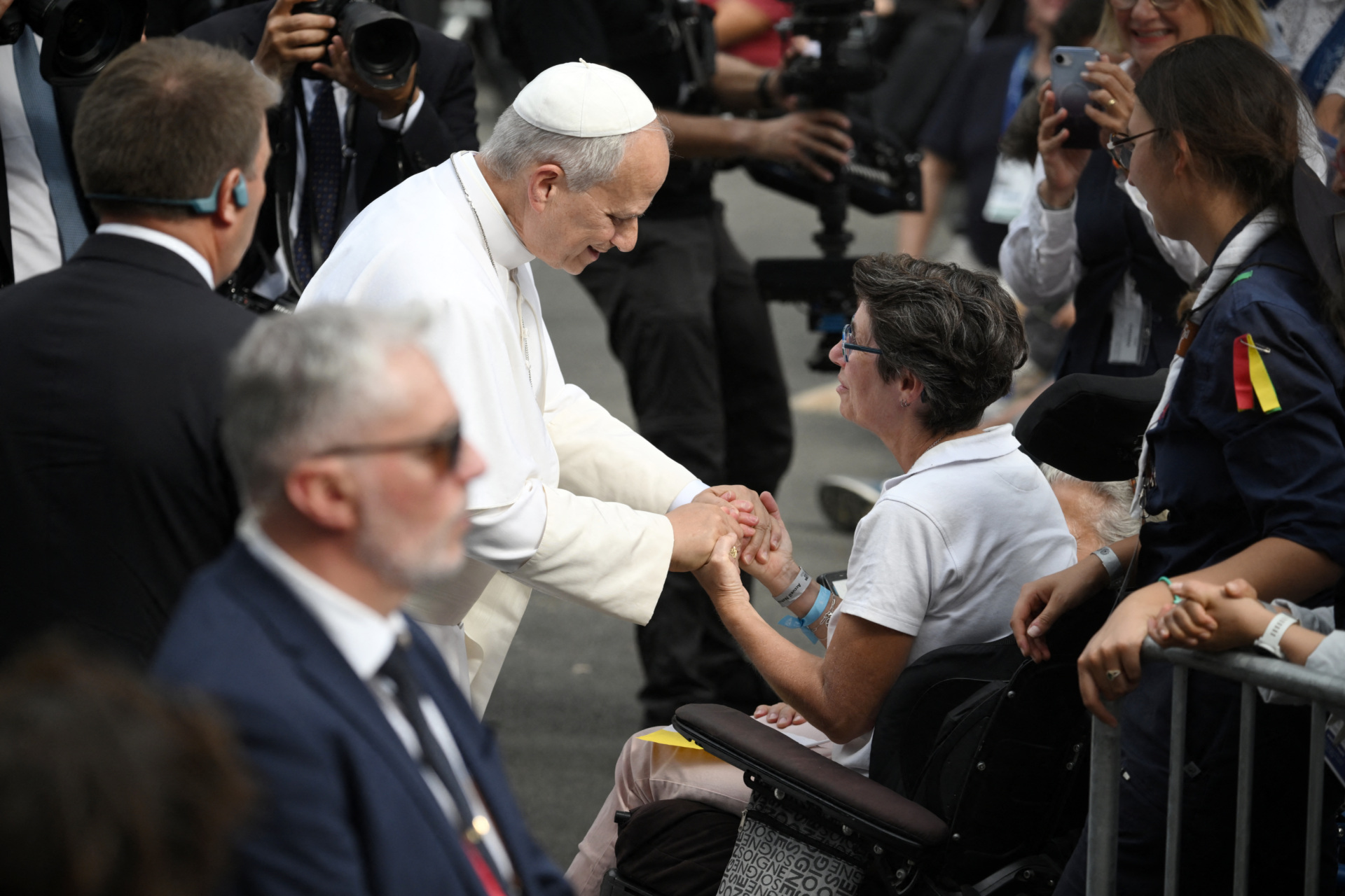 Pope Leo XIV cheers a woman on a wheelchair during his meeting with support workers and service users of the structure Accueil Notre-Dame at the Shrine of our Lady of Lourdes, during his visit in Lourdes southwestern France, on September 27, 2026 on the third day of his trip to France. (Photo by Ed JONES / AFP via Getty Images)