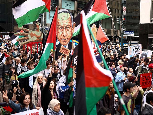 Protesters hold an image of Israeli Prime Minister Benjamin Netanyahu bearing the word "Criminal" above a crowd waving Palestinian flags and holding "Free Palestine" signs during a demonstration on the day of his address to the 81st United Nations General Assembly in New York, on September 24, 2026. (Photo by CHARLY TRIBALLEAU / AFP via Getty Images)